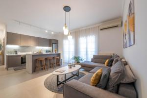 a living room with a couch and a table at A Comfortable Stay with Balcony and Easy Parking near Kalamata Center in Kalamata