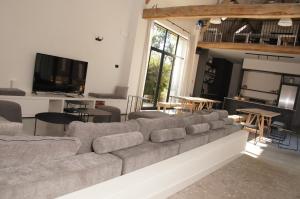 a living room with a large couch and a table at Vakantiewoning Hof ter Heidje in Maarkedal