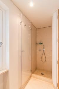 a shower with a glass door in a bathroom at Belle Arti in Bergamo