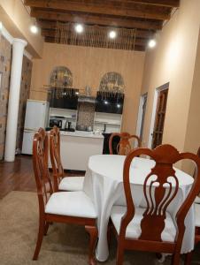 a dining room with a table and chairs and a kitchen at Ayvan Eco Hostel in Tashkent