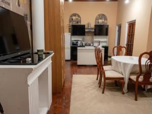 a kitchen and dining room with a table and chairs at Ayvan Eco Hostel in Tashkent