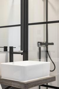 a white sink in front of a mirror at Hakefjorden by Workershotel in Källsby +46 photos