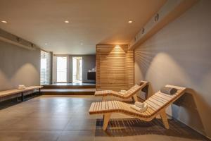 a living room with two chairs and a couch at eXo Fly Level 4 Hotel Stuttgart-Flughafen in Ostfildern