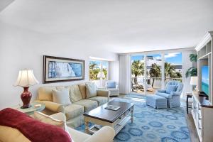 a living room with a couch and chairs at Lighthouse Point A311 in Sanibel