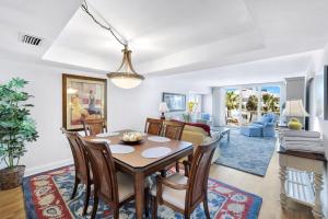 a dining room and living room with a table and chairs at Lighthouse Point A311 in Sanibel