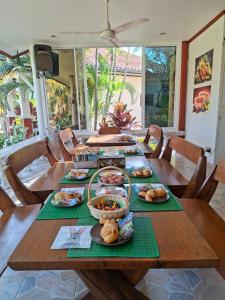 a long wooden table with plates of food on it at Stella Resort in Sam Roi Yot