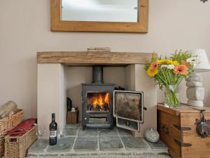 a fireplace in a living room with flowers and a mirror at Stourcliffe House in Bournemouth