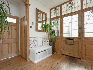 a room with wooden doors and windows and a bench at Stourcliffe House in Bournemouth +23 photos