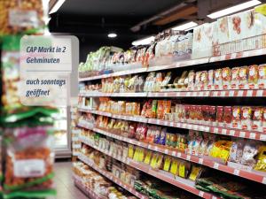 a grocery store aisle with shelves filled with food at Zimmer Haus Krabbe für Kurzaufenthalt und Geschäftsreise, zwischen Bremerhaven und Cuxhaven in Wremen