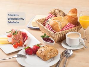 a table with a breakfast of bread and fruit and a cup of coffee at Zimmer Haus Krabbe für Kurzaufenthalt und Geschäftsreise, zwischen Bremerhaven und Cuxhaven in Wremen