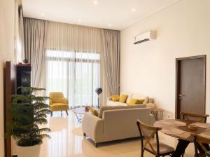a living room with a couch and a table at Wateera Jebel Sifah-Beachfront & Golf View in As Sīfah