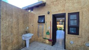 a bathroom with a toilet on the side of a building at Villa Garoupeta in Bombinhas +107 photos