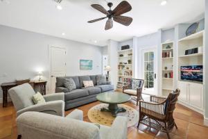 a living room with a couch and a ceiling fan at Villa Elena in Captiva