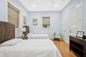 a bedroom with a bed and a desk and a chair at Villa Elena in Captiva +32 photos