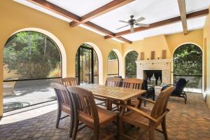 a dining room with a table and chairs and a fireplace at Villa Elena in Captiva