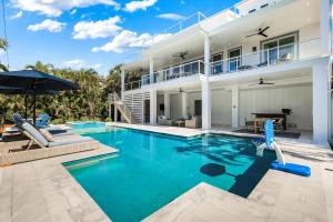 a swimming pool in front of a house at Cabana Blu in Captiva