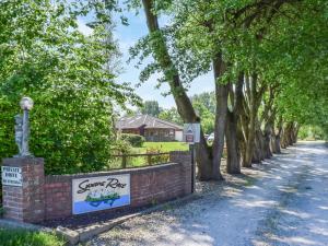 a sign for a yard with trees on a road at Quail Cottage - Uk50659 in Little Singleton