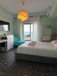a bedroom with a bed and a view of the ocean at Hermes View in Kavála