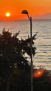 a street light with the sunset in the background at Hermes View in Kavála