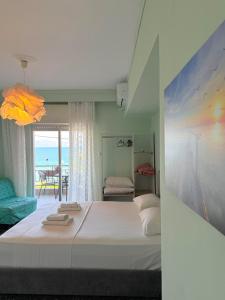 a bedroom with a bed and a view of the ocean at Hermes View in Kavála