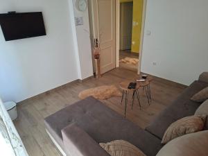 a living room with a couch and a table at Stan na dan Emili 2 in Valjevo +4 photos