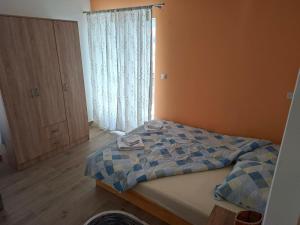 a bedroom with a bed and a window at Stan na dan Emili 2 in Valjevo