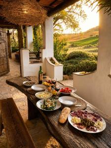 a wooden table with plates of food on it at Finca Dariana Padel & Pool in Alora