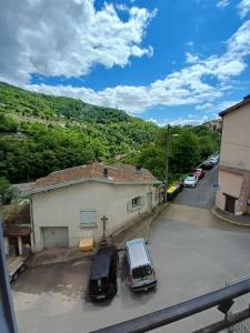 two cars parked in a parking lot next to a building at La Chaloupe 4 in Thiers