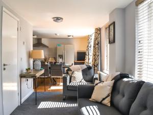 a living room with a couch and a table at Summerleaze House in Bude
