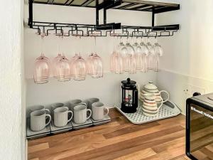 a kitchen with glasses and mugs on a shelf at Summerleaze House in Bude