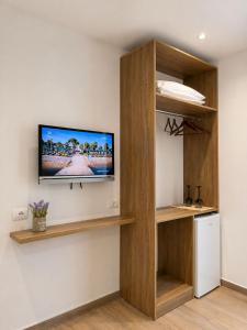 a room with a flat screen tv on a wall at Vila Beqja in Durrës