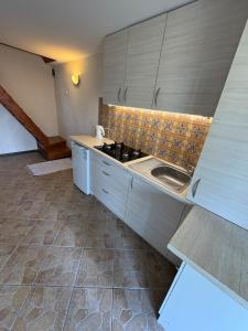 a kitchen with a sink and a stove at Przystań Kownatki in Kozłowo