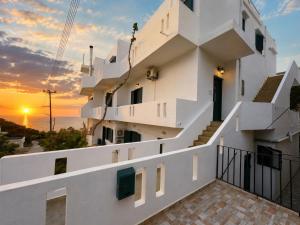 a building with the sunset in the background at 4Seasons Sfakia in Hora Sfakion
