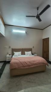 a large bed in a room with a ceiling fan at Tranquil Nature Resort in Rāipur +36 photos