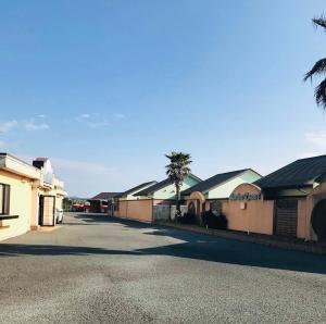a row of houses with palm trees in a street at バリアンリゾート山口BarianResort Yamaguchi in Sanyoonoda