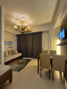 a living room with a dining table and a bedroom at Tropical Escape at Pico De Loro in Nasugbu