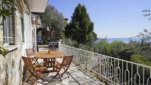 a table and chairs on the balcony of a house at Villa Samanta in Gardone Riviera