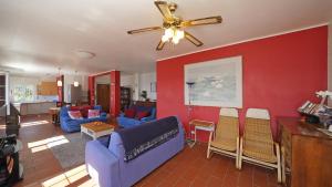 a living room with a blue couch and a ceiling fan at Villa Samanta in Gardone Riviera