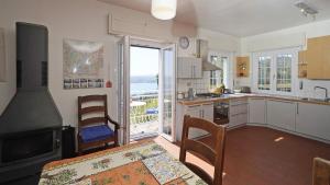 a kitchen with a view of the ocean at Villa Samanta in Gardone Riviera