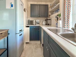 a kitchen with a sink and a refrigerator at Serendipity in Molland