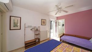 a room with two beds and a ceiling fan at Villa Samanta in Gardone Riviera +62 photos