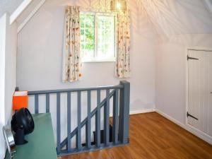 a room with a staircase and a window at Serendipity in Molland +6 photos