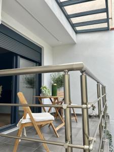 a balcony with a chair and a table at Βίλα Βασιλική in Elassona