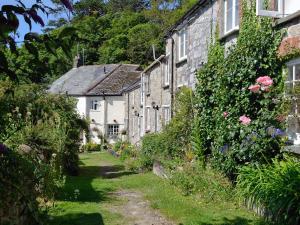 a row of stone houses in a garden at Gwelmor in Charlestown