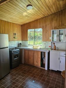 a kitchen with a refrigerator and a stove top oven at Apu Ecolodge in Caraz
