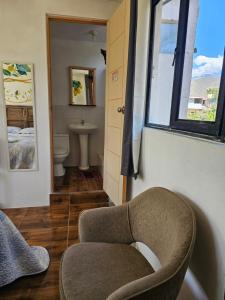 a bathroom with a chair and a toilet and a window at Apu Ecolodge in Caraz +137 photos