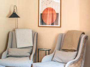 two chairs and a lamp in a room at Cleugh Foot in Longtown