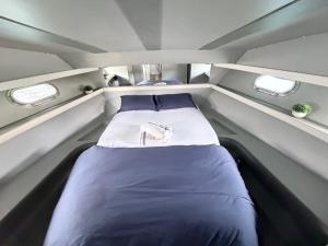 a small bed in the middle of a boat at Confortable Yatch in Barcelona +13 photos