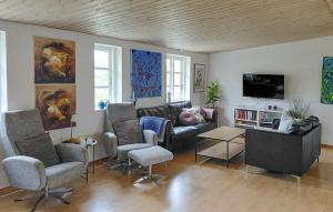 a living room with a couch and chairs and a tv at 2 Bedroom Lovely Apartment In Gørlev in Gørlev
