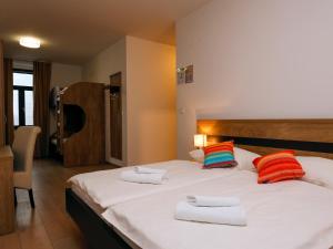 a bedroom with a large bed with towels on it at Guesthouse Rajski okusi Sveta Gora in Solkan +17 photos